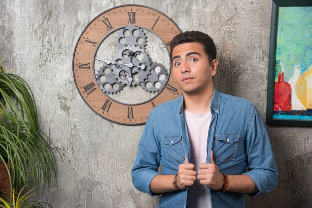 Free photo young man posing on marble background. high quality photo