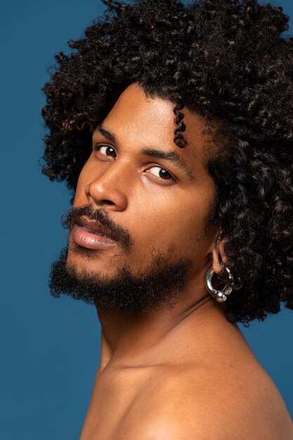 Young man posing in studio side view