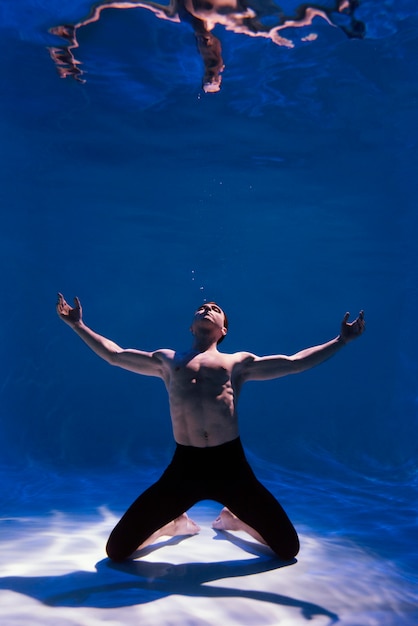 Free photo young man posing submerged underwater