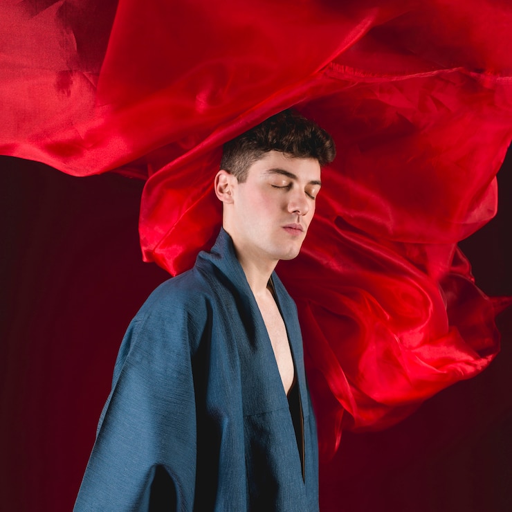 Free Photo young man posing with red cloth