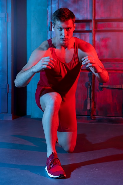 Free photo young man posing in wrestling gear and clothing