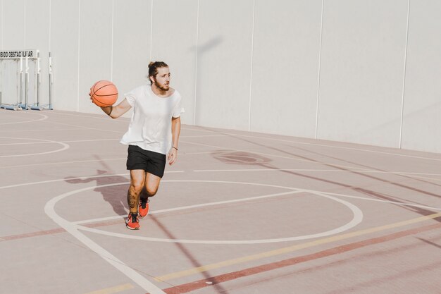 Young man practicing basketball