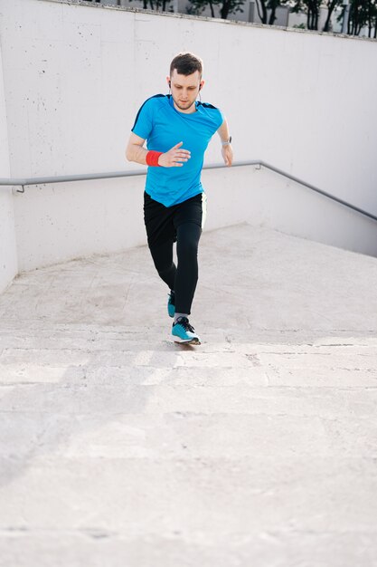 Young man practicing interval workout on stairs