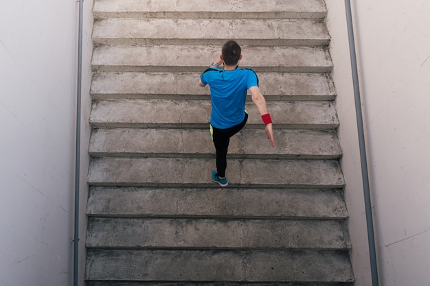 Young man practicing interval workout on stairs