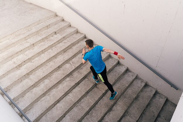 Young man practicing interval workout on stairs