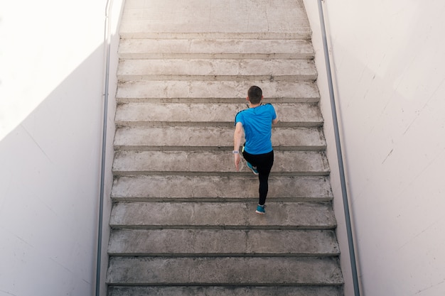 Young man practicing interval workout on stairs