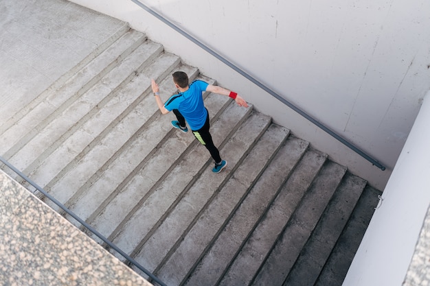 Free photo young man practicing interval workout on stairs