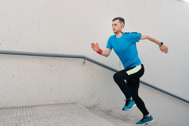 Free photo young man practicing interval workout on stairs