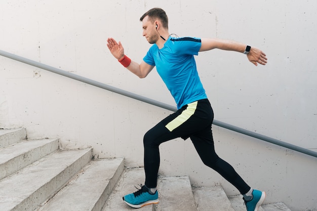 Free photo young man practicing interval workout on stairs