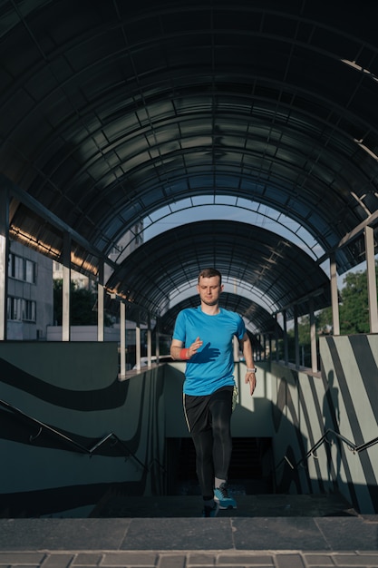 Young man practicing interval workout on stairs