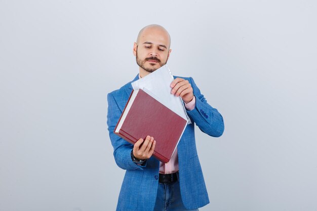 Young man putting the file in a folder