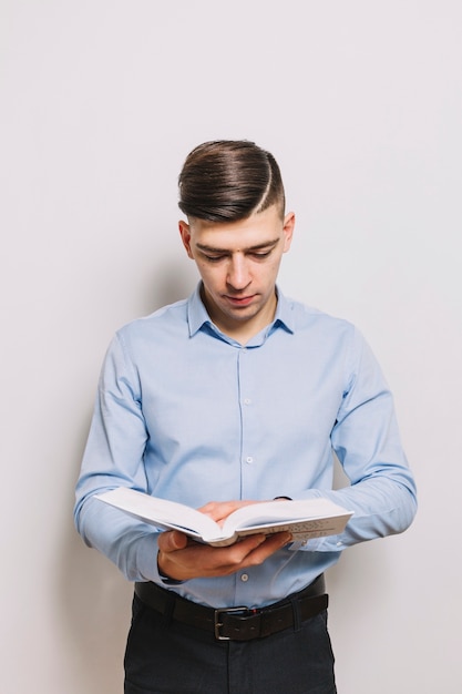 Free photo young man reading book