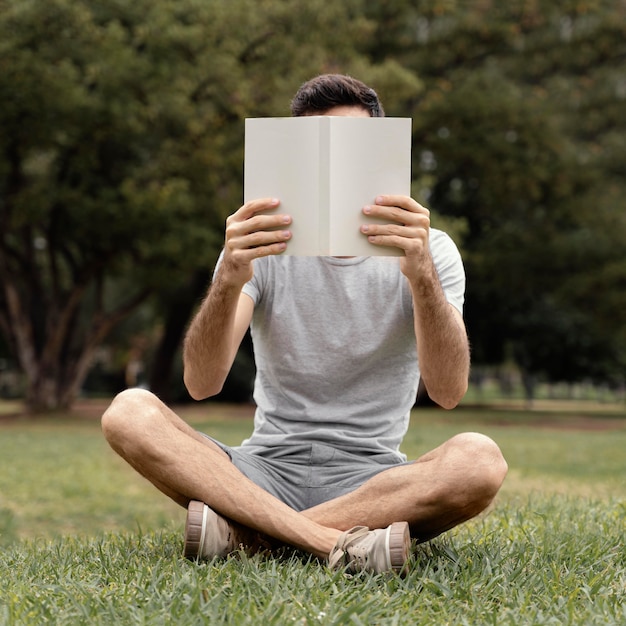 Young man reading an interesting book