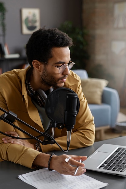 Free photo young man recording podcast medium shot