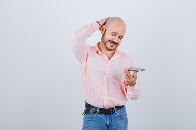 Young man recording a voice message on mobile phone