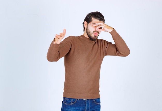 Young man rejecting someone showing a gesture of disgust.