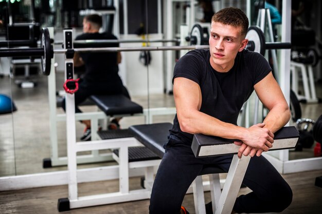 Young man resting in the break between sets