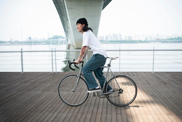 Free photo young man riding his bike