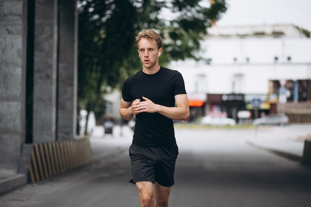 Young man running in the city in the morning