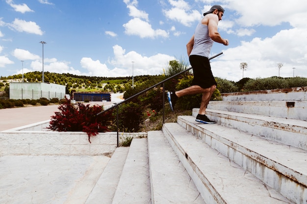 Young man running on staircase