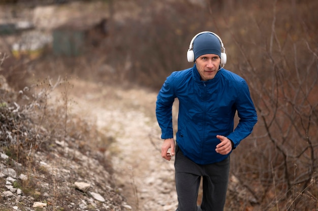 Young man running on trail in nature