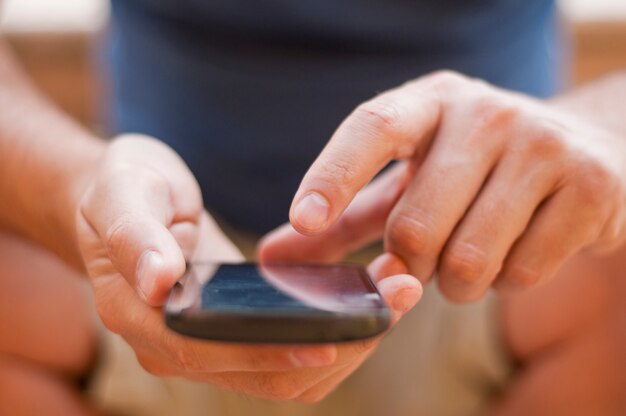 Young man sending text to his girlfriend