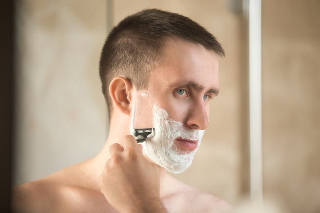 Young man shaving