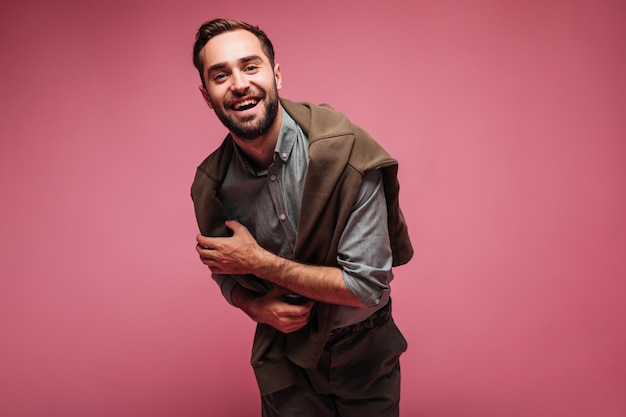 Free photo young man in shirt looking into camera and smiling