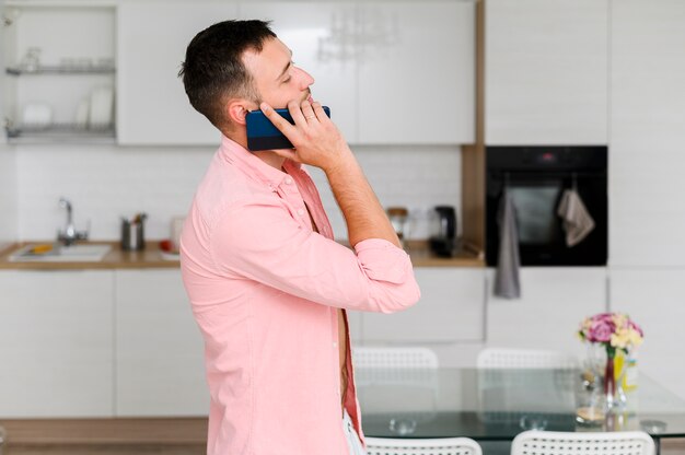 Young man in shirt with smartphone at his ear