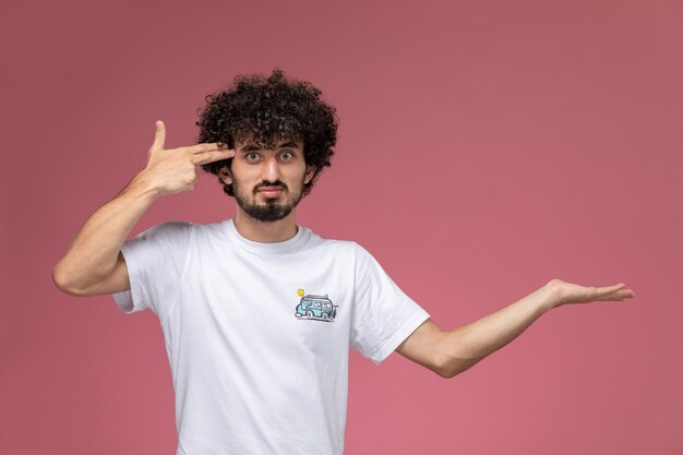 young man shooting himself with his fingers