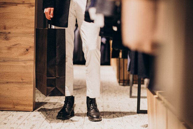 Young man shopping at menswear shop