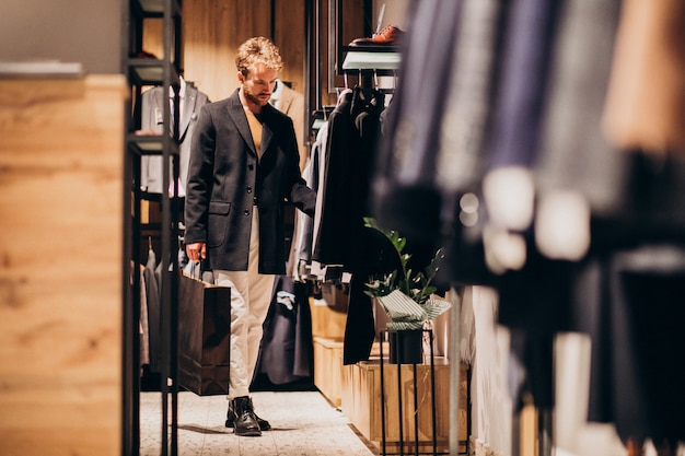 Young man shopping at menswear shop