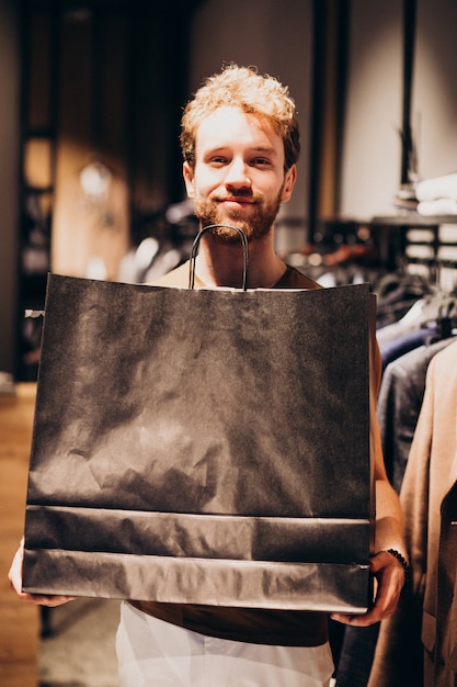 Free photo young man shopping at menswear shop