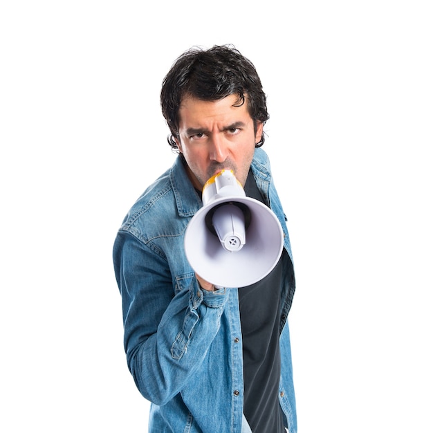 Young man shouting over isolated white background