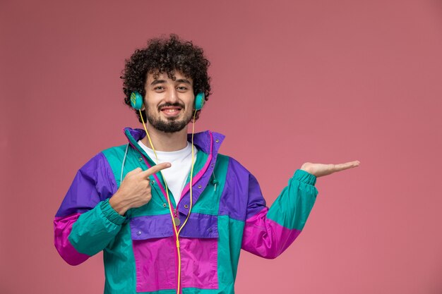 young man showing his empty hand and also smiling