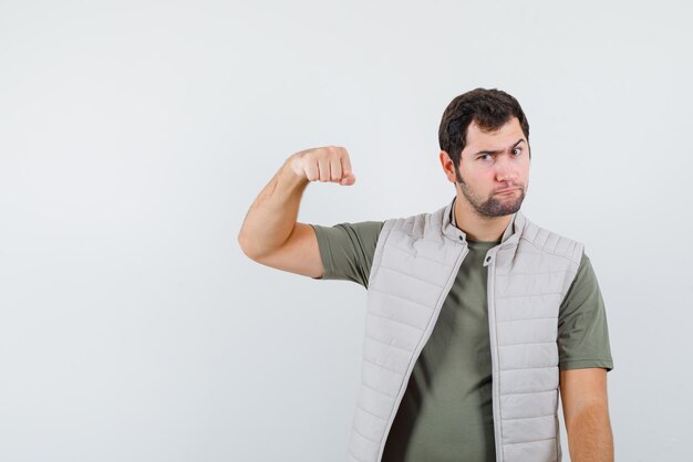 Young man showing his fists on white background