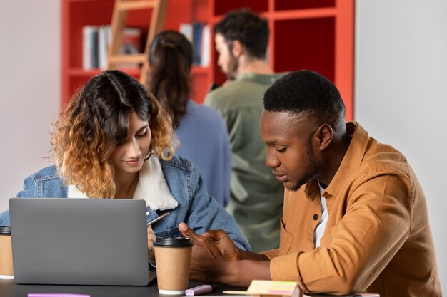 Young man showing his friend information from his notes