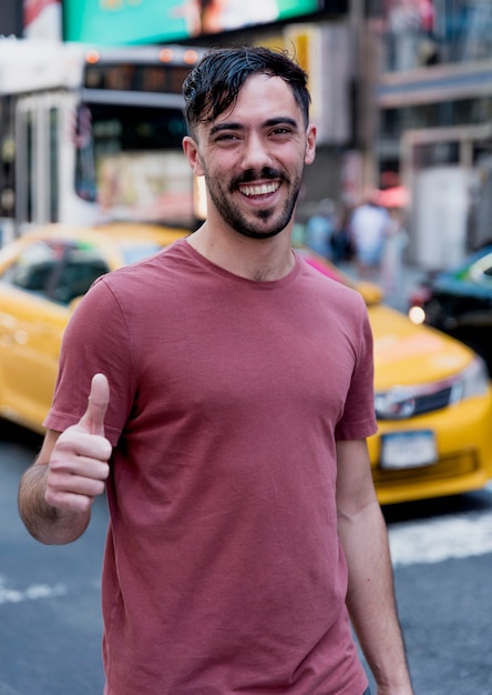 Free photo young man showing ok sign for camera