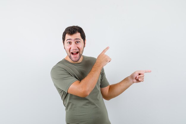 Young man showing the right with his fingers on white background