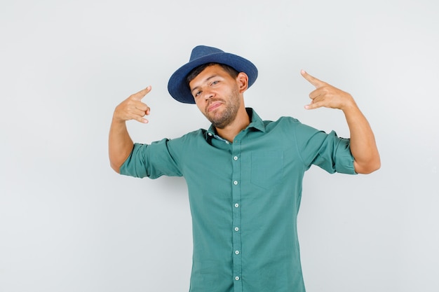 Young man showing rock symbol in shirt