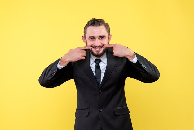 Young man showing smiling gesture