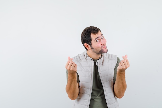 Young man showing a tasty hand gesture on white background