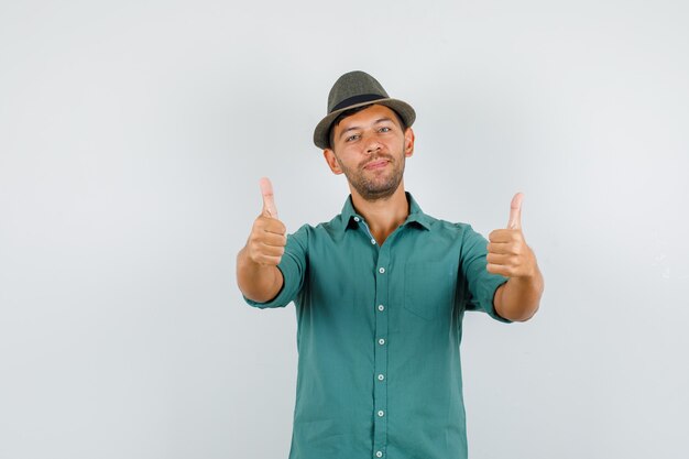 Young man showing thumbs up in shirt