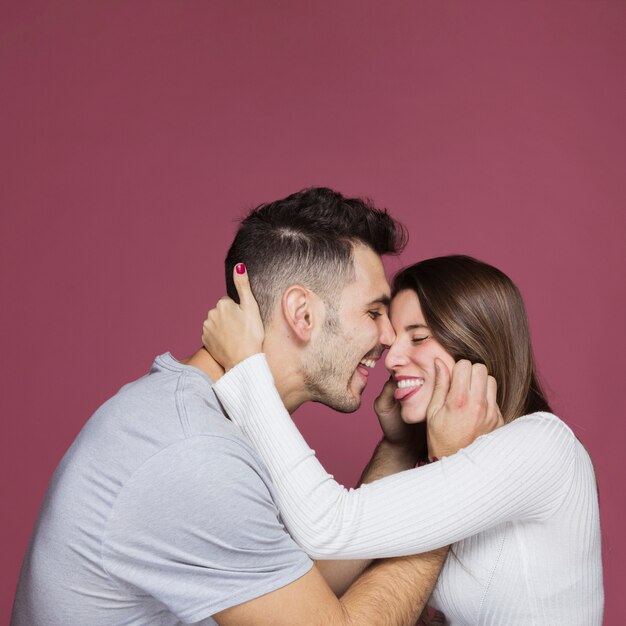 Young man showing tongues with attractive woman