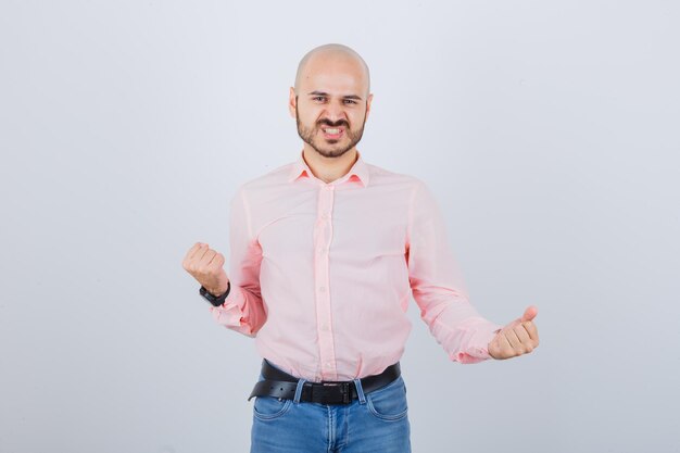 Young man showing winner gesture