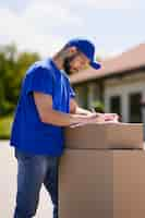 Free photo young man signing delivery papers