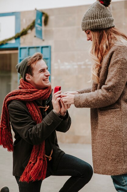 Young man sitting kneeled and proposing to girlfriend