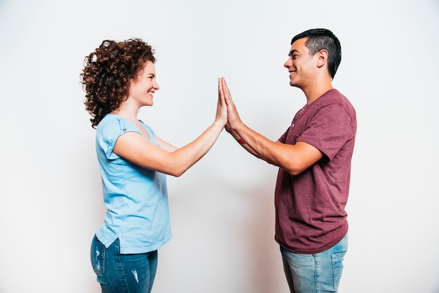 Young man and smiling woman playing patty cake game