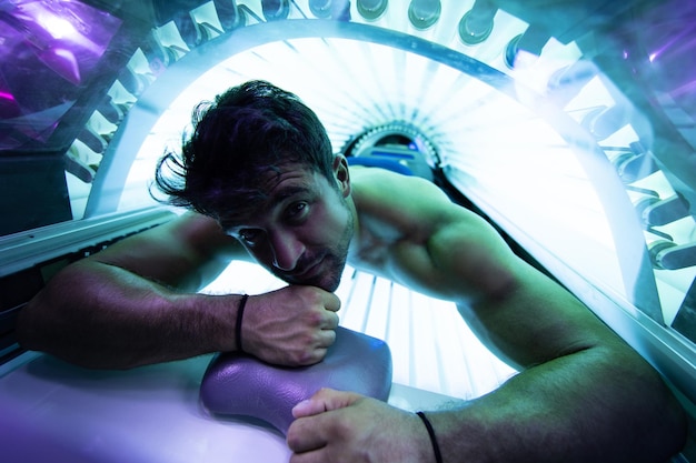 Young Man At Solarium In Beauty Salon