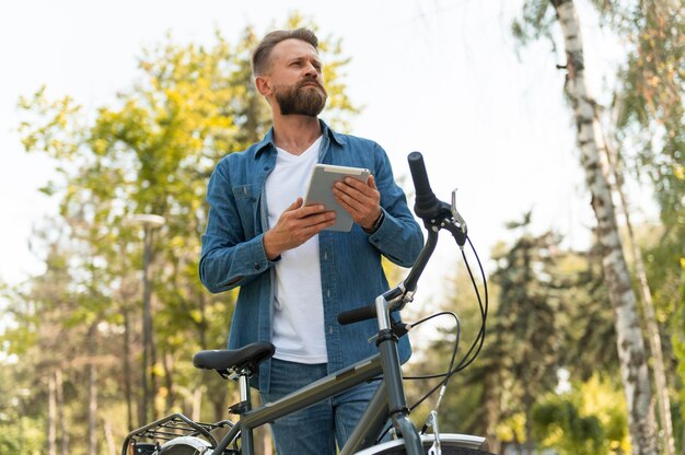 Young man spending time outside with his bike